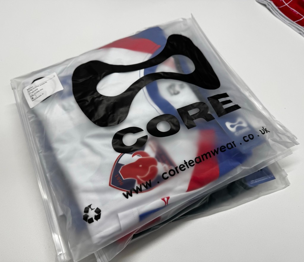 A CORE Teamwear shirt sealed in a labelled bag, with the club badge visible through the packaging